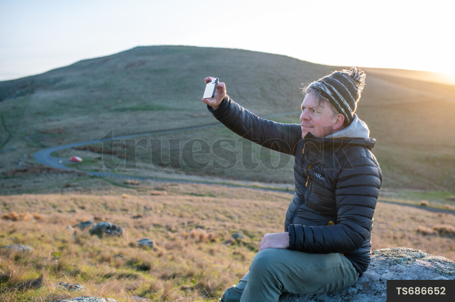 Man taking selfie on rock