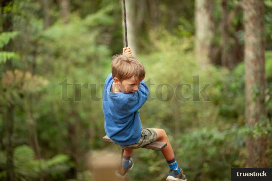 Boy on rope swing