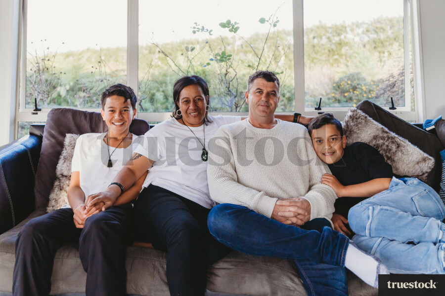 Portrait of loving family sitting on the couch together