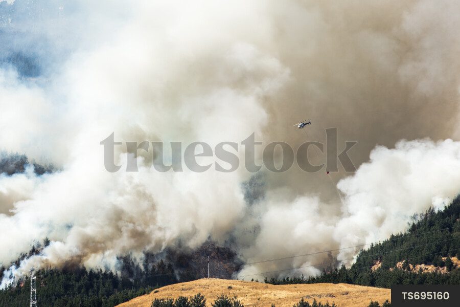Helicopter flying over Port Hills fire, Christchurch, New Zealand