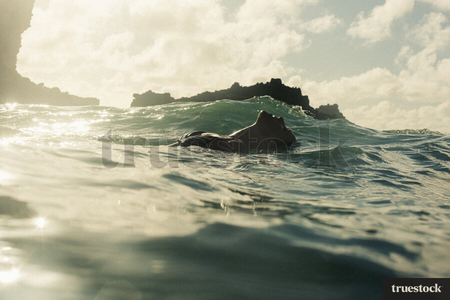 Woman Swimming at Piha Beach