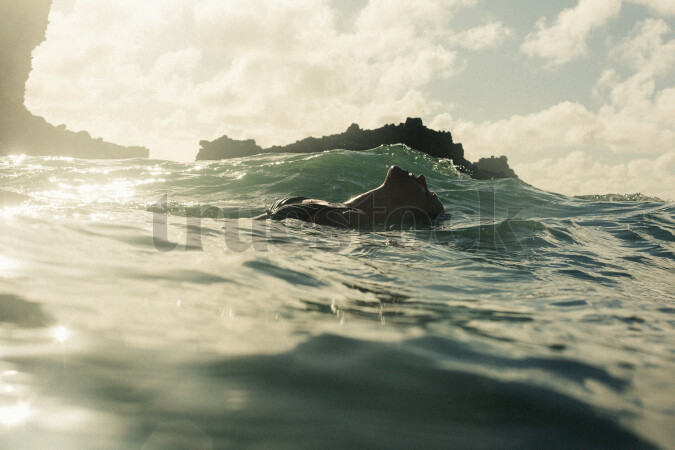 Woman Swimming at Piha Beach