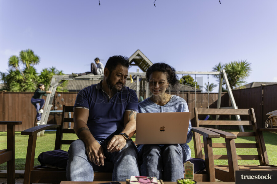 Parents on Laptop outside