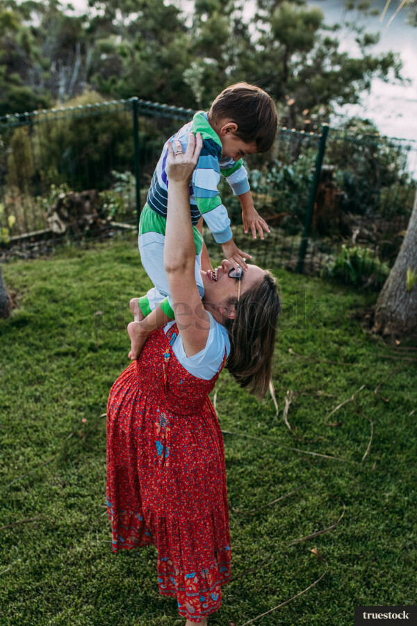 Mother lifting up son