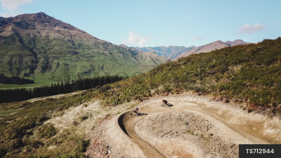 Men mountain biking on dirt trail