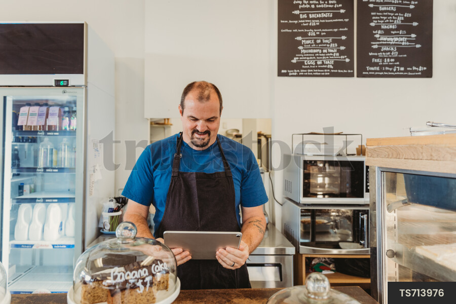 Worker Using iPad at Cafe