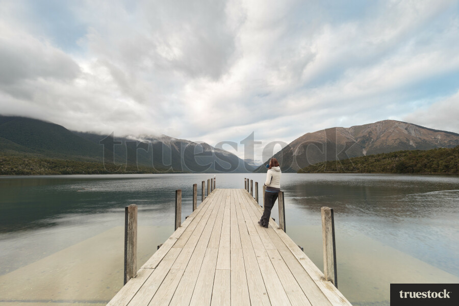 Adult on a lake's wharf