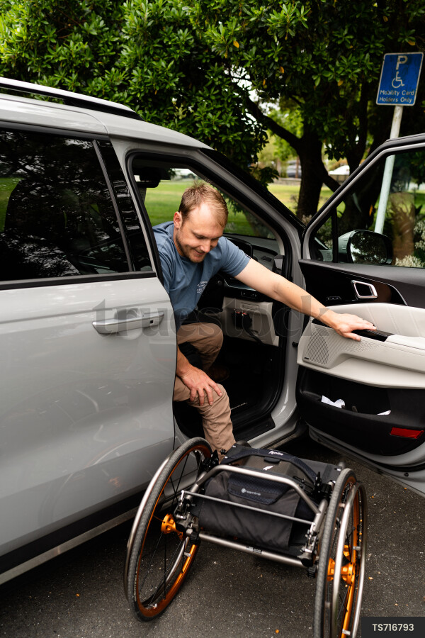 Man with wheelchair in car