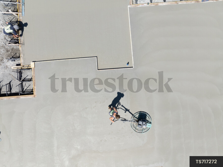 Construction workers working on concrete foundation
