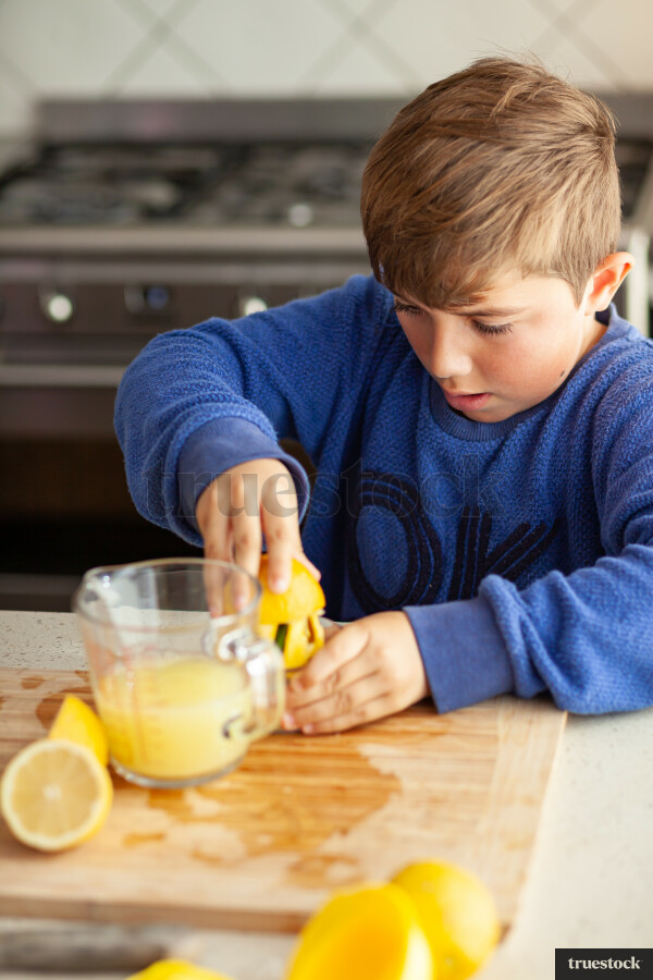 Young children making lemondade