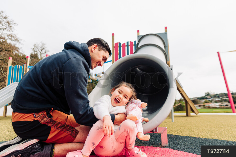 Young Girl on Slide at Park