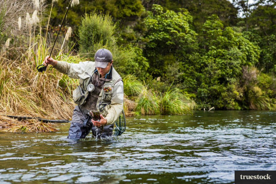 Fisherman Catching Fish With Hand