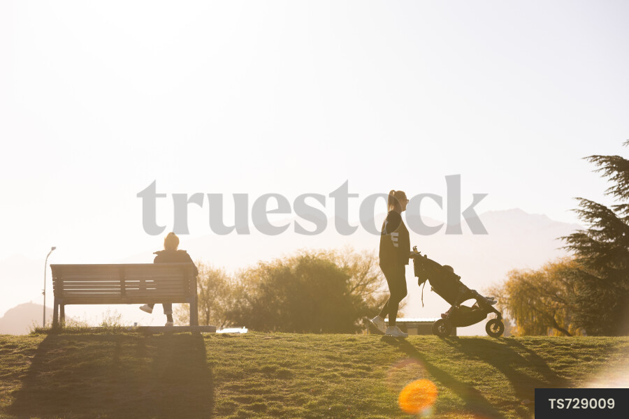 Woman walking with son in stroller