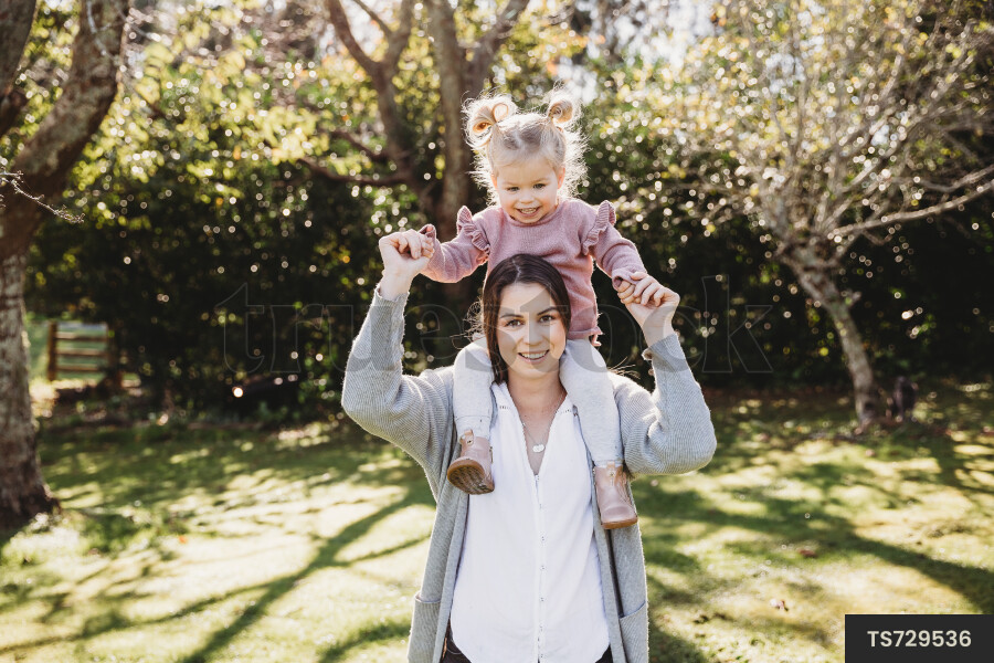 Mother Carrying Daughter on Shoulders