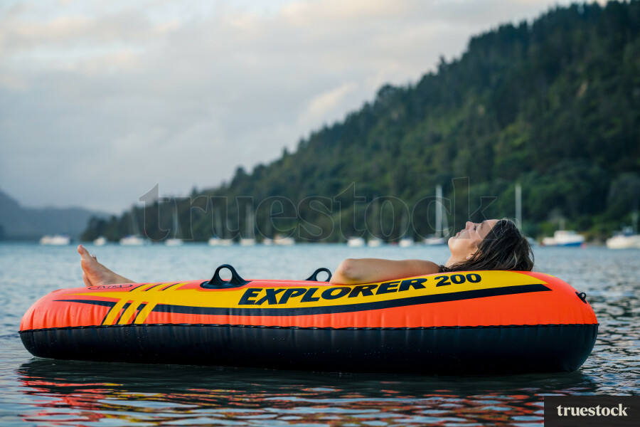 Woman Relaxing in an Inflatable Boat