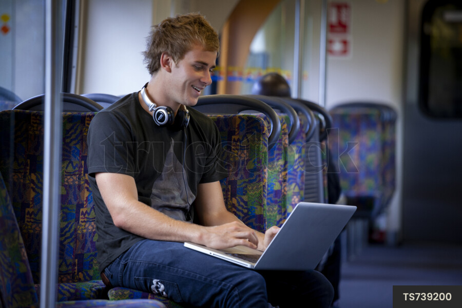 Man Using Laptop on Train