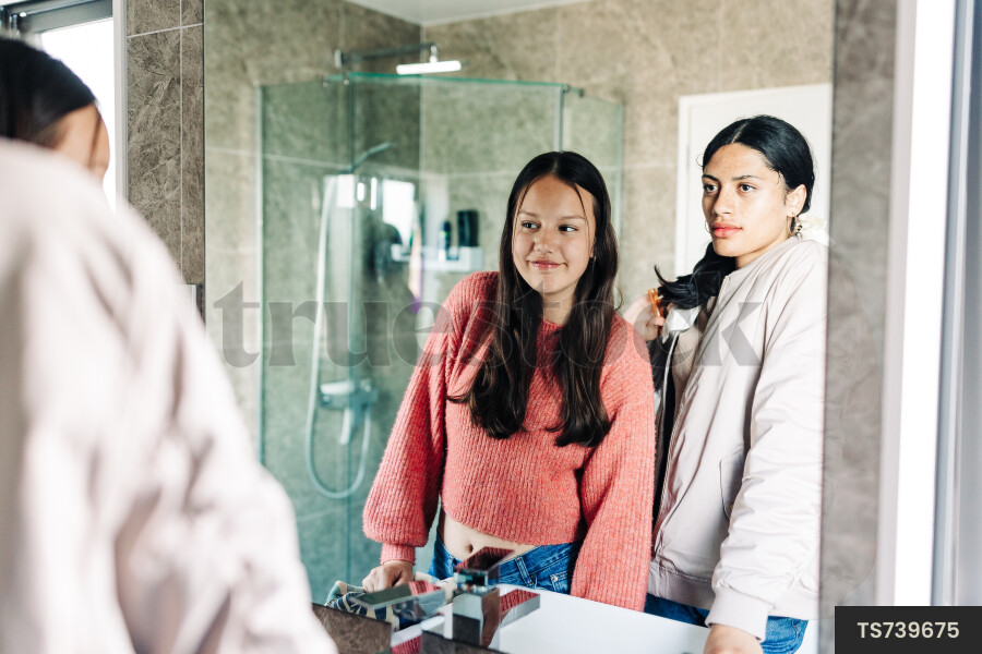Friends getting ready in bathroom