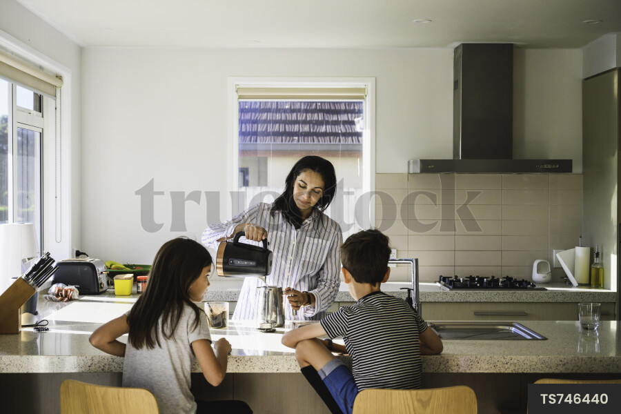 Young Kids Eating Breakfast in Kitchen