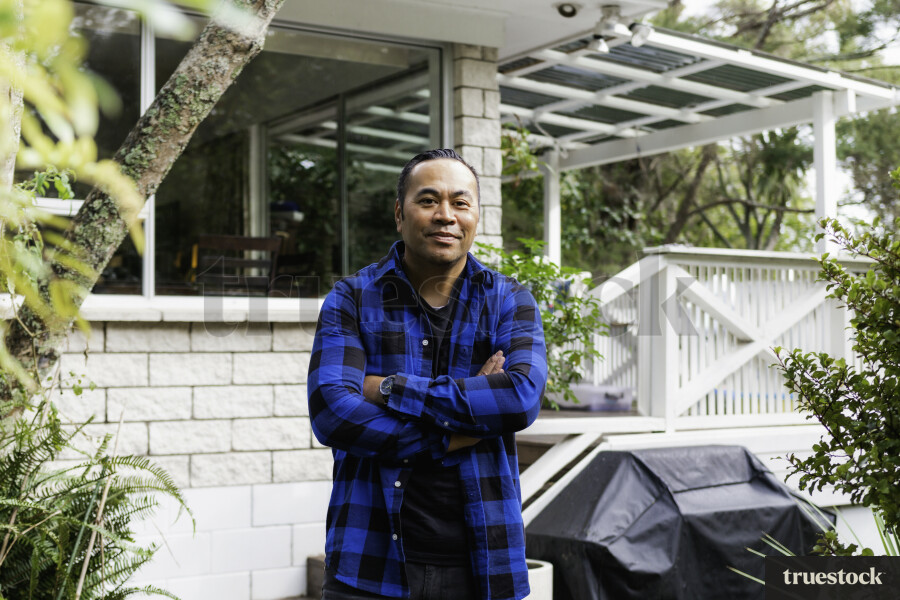 Samoan Man standing outside his Home