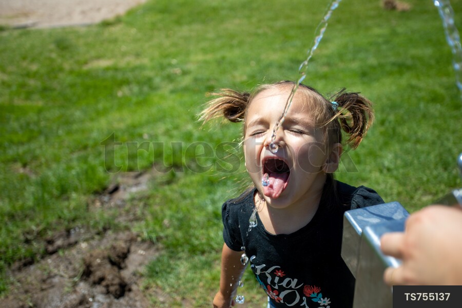 Young Girl Using Water Fountain