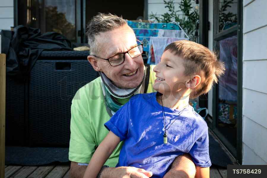 Smiling man with his grandson