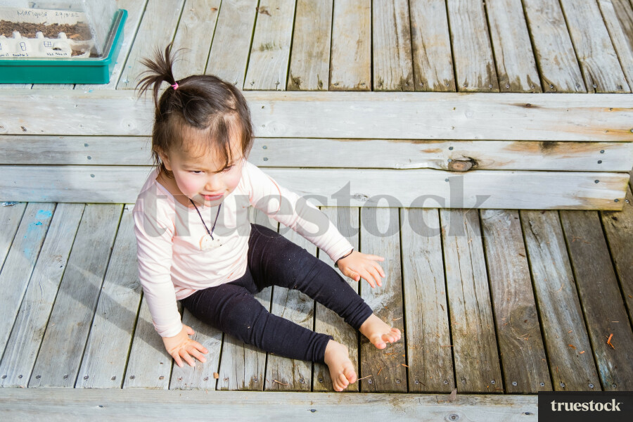 Toddler Sitting on the Deck