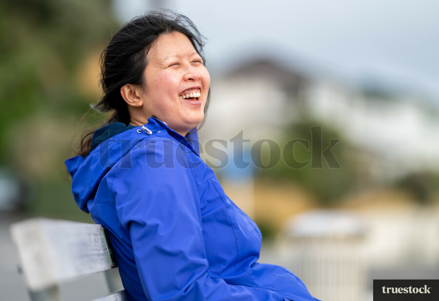 Chinese woman sitting on bench
