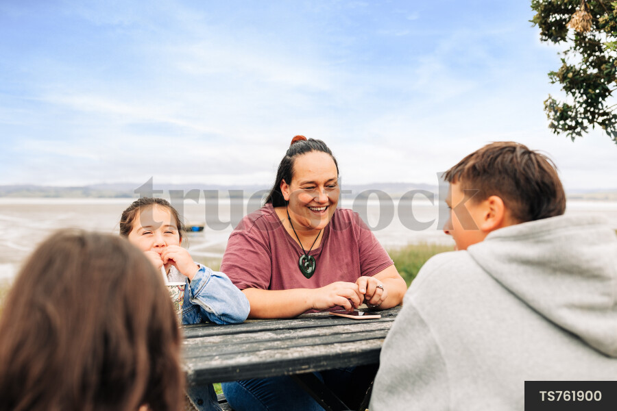 Family sitting on picnic table