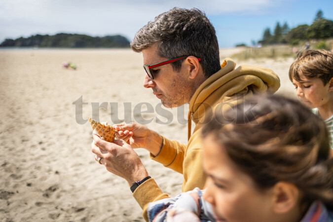 Father and Kids with Ice Cream on Beach