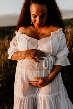 Woman Standing in Field for Maternity Shoot