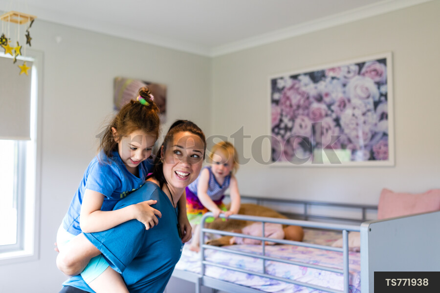 Mother Giving Daughter Piggyback
