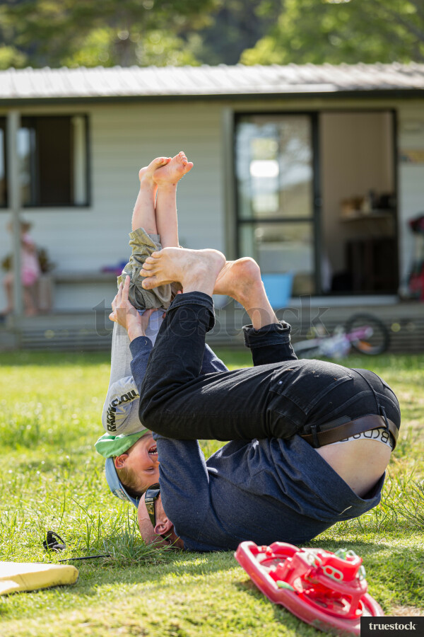Dad playing with child on the grass