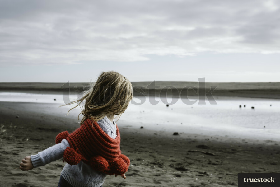 Girl Running Along the Beach