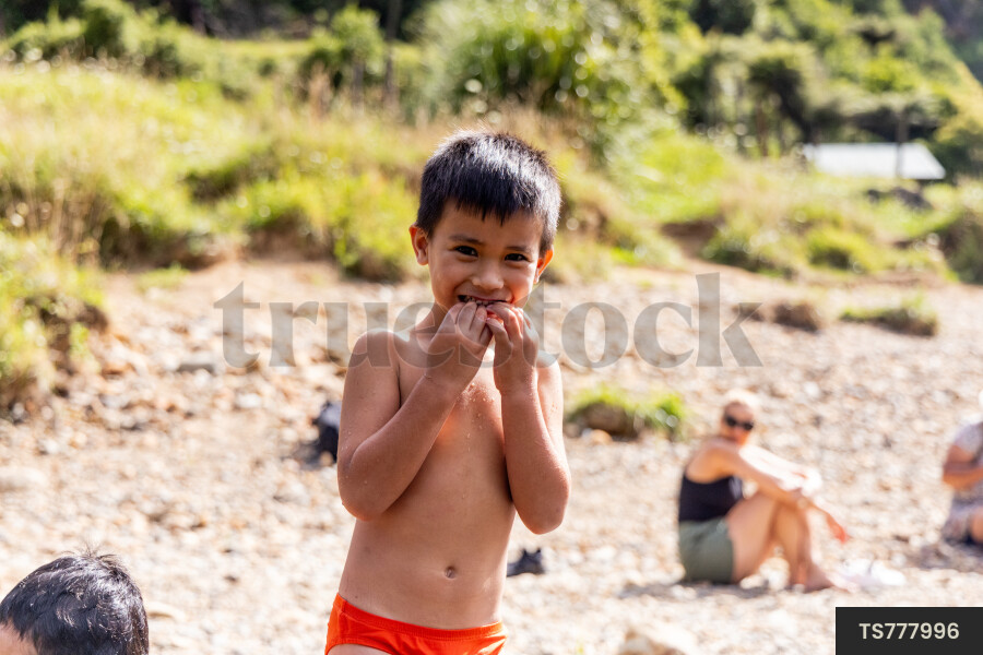 Smiling boy on riverbank