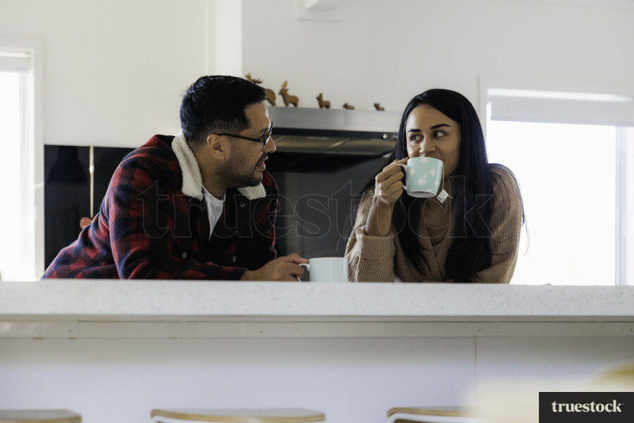 Parents chat in Kitchen with cups of Tea