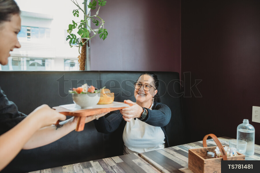 Customer Receiving Food at Cafe