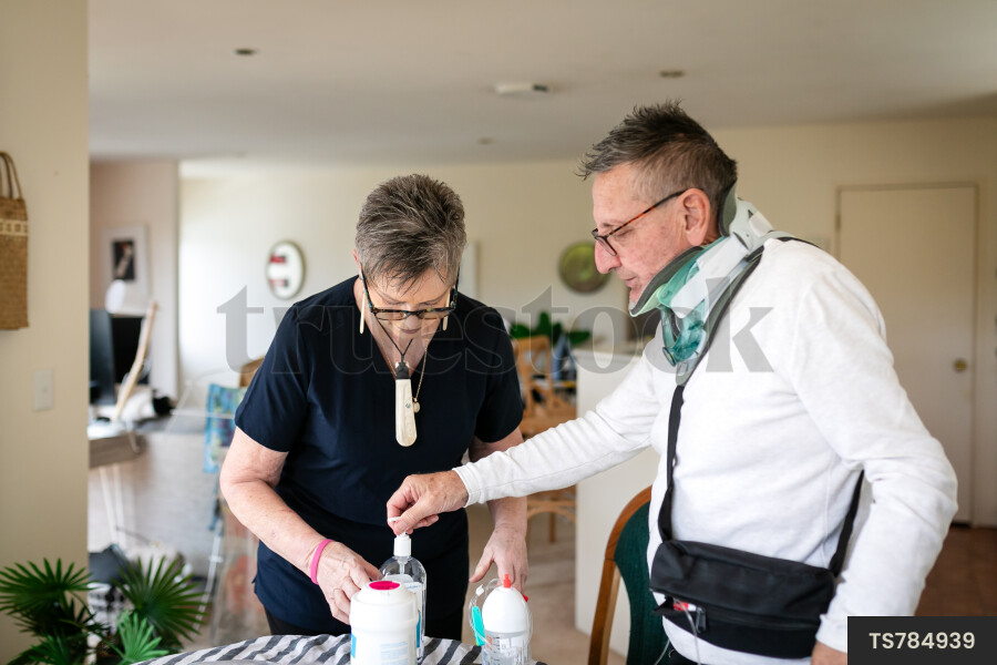 Health carer giving medicine to patient with neck brace