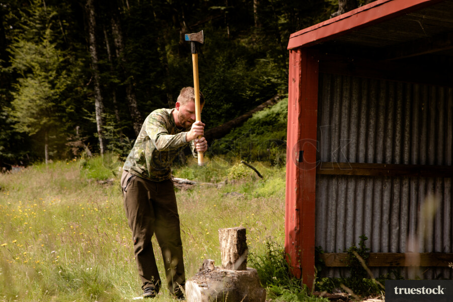 Dad cutting firewood with an axe