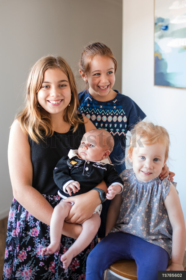 Smiling girls with baby daughter