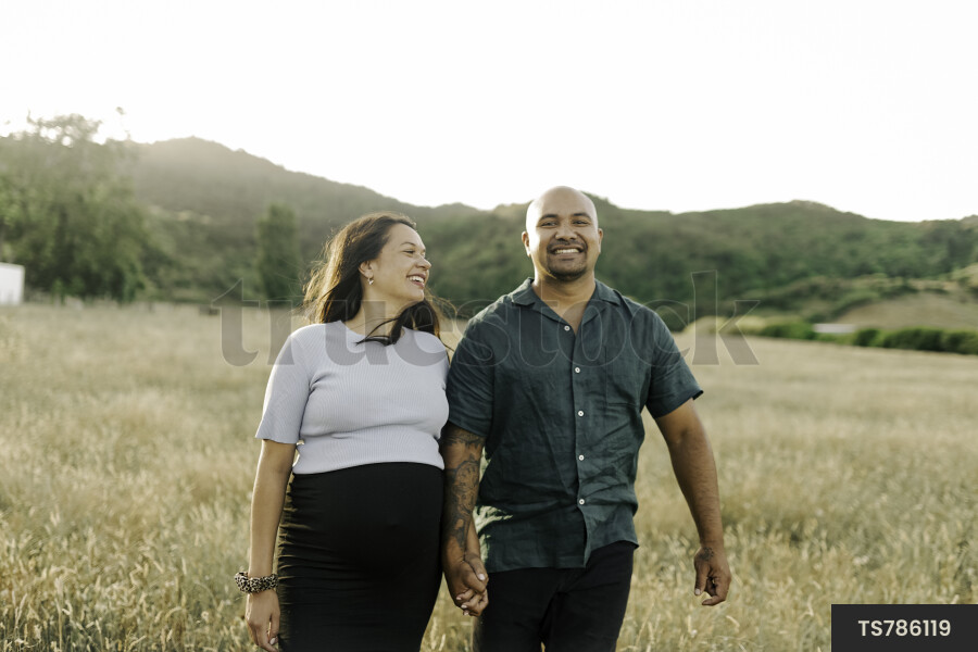 Husband and Pregnant Wife in Field