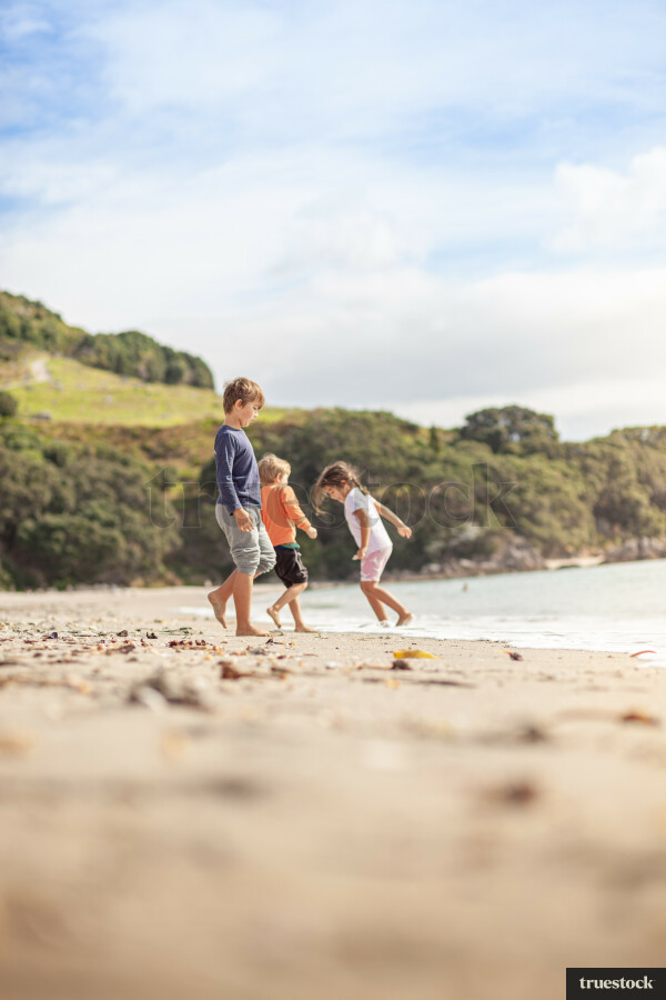 Children playing at the beach on the sand