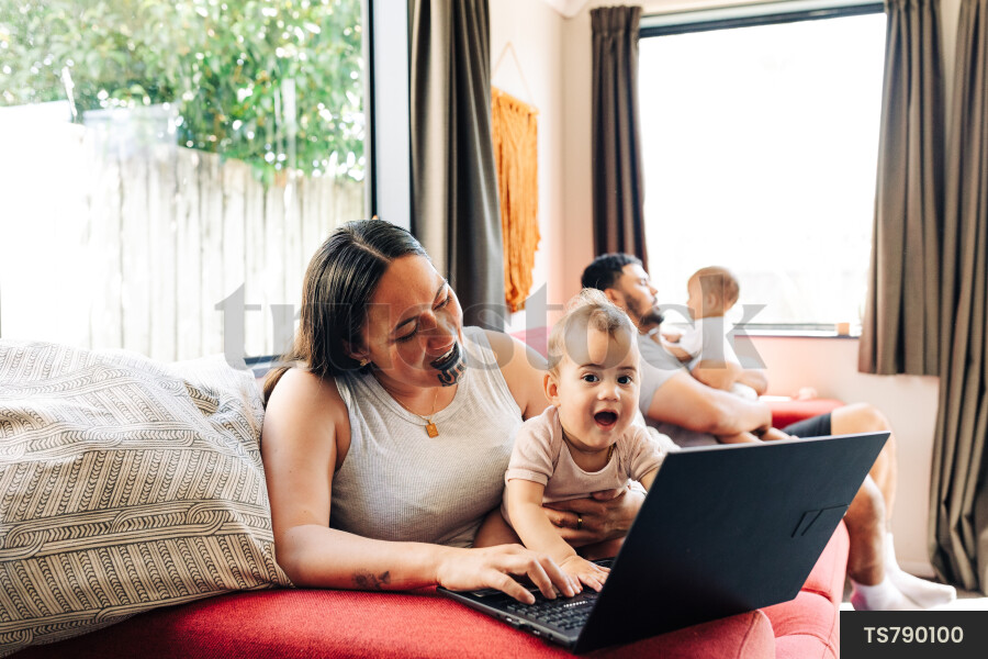 Mother and Kids Using Laptop on Couch