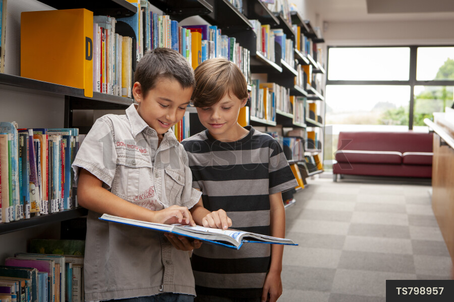 Boys Reading Book in Library
