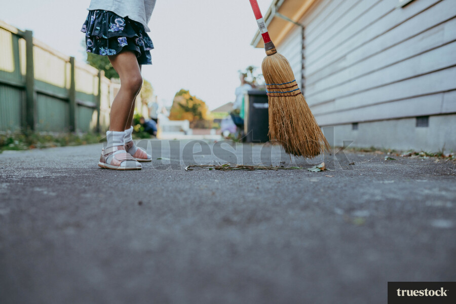 Child sweeping up leaves