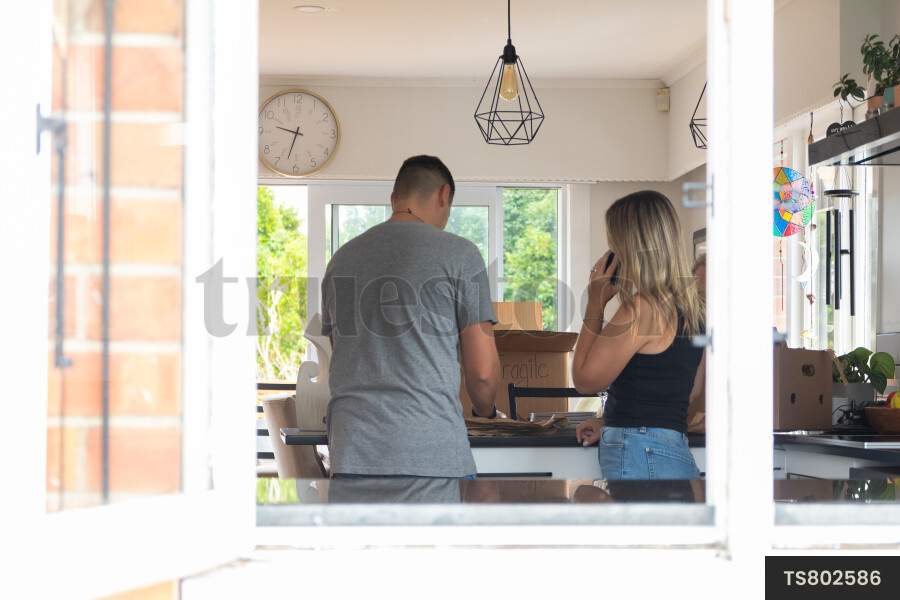 Couple packing in kitchen