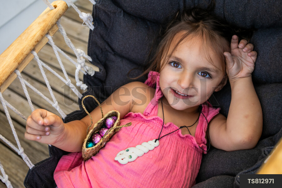 Girl lying in hammock with easter eggs