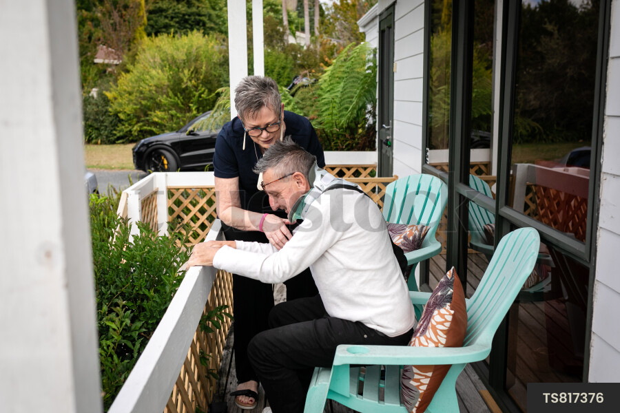 Health carer sitting with patient on deck