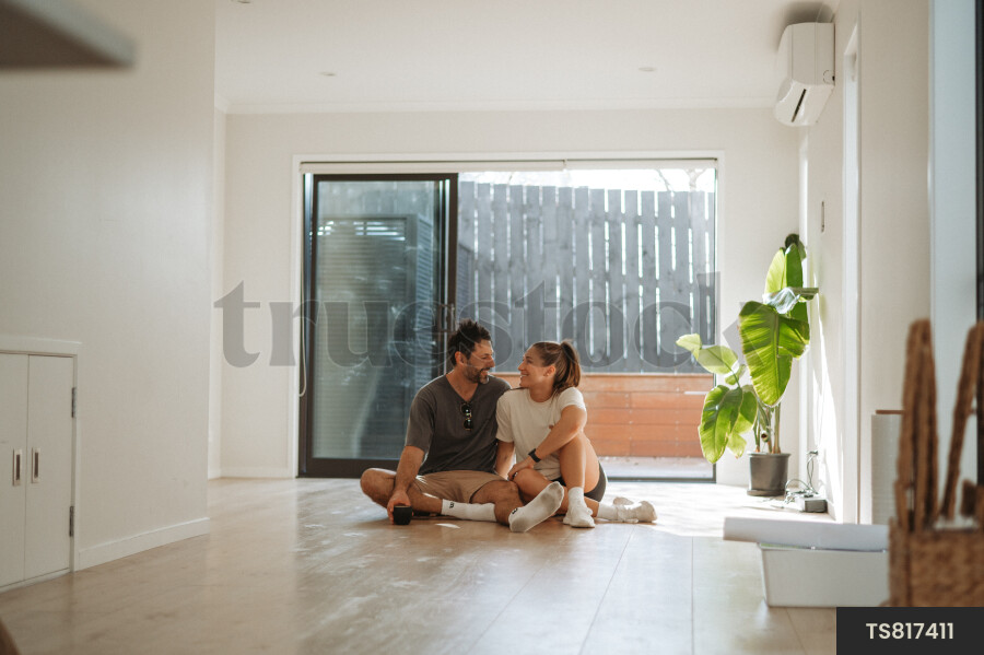 Happy couple sitting in new house