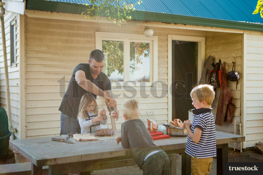 Father Cooking in the Backyard with Kids