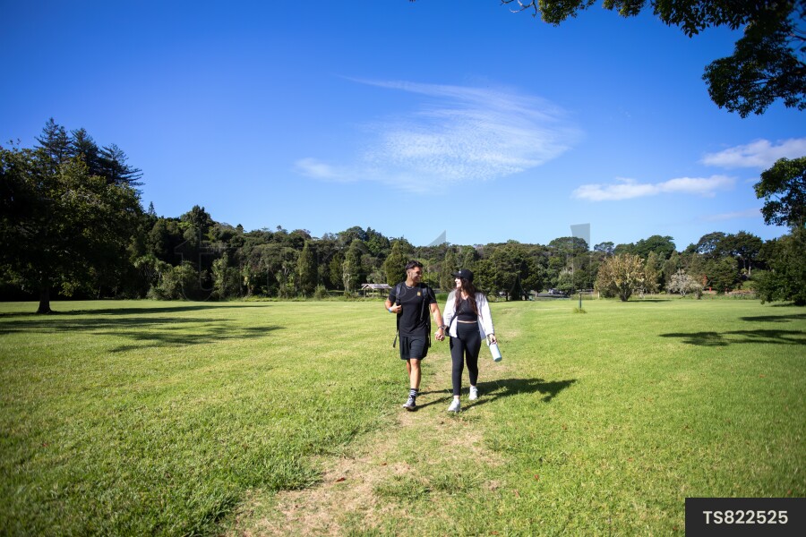 Couple Walking Through Park